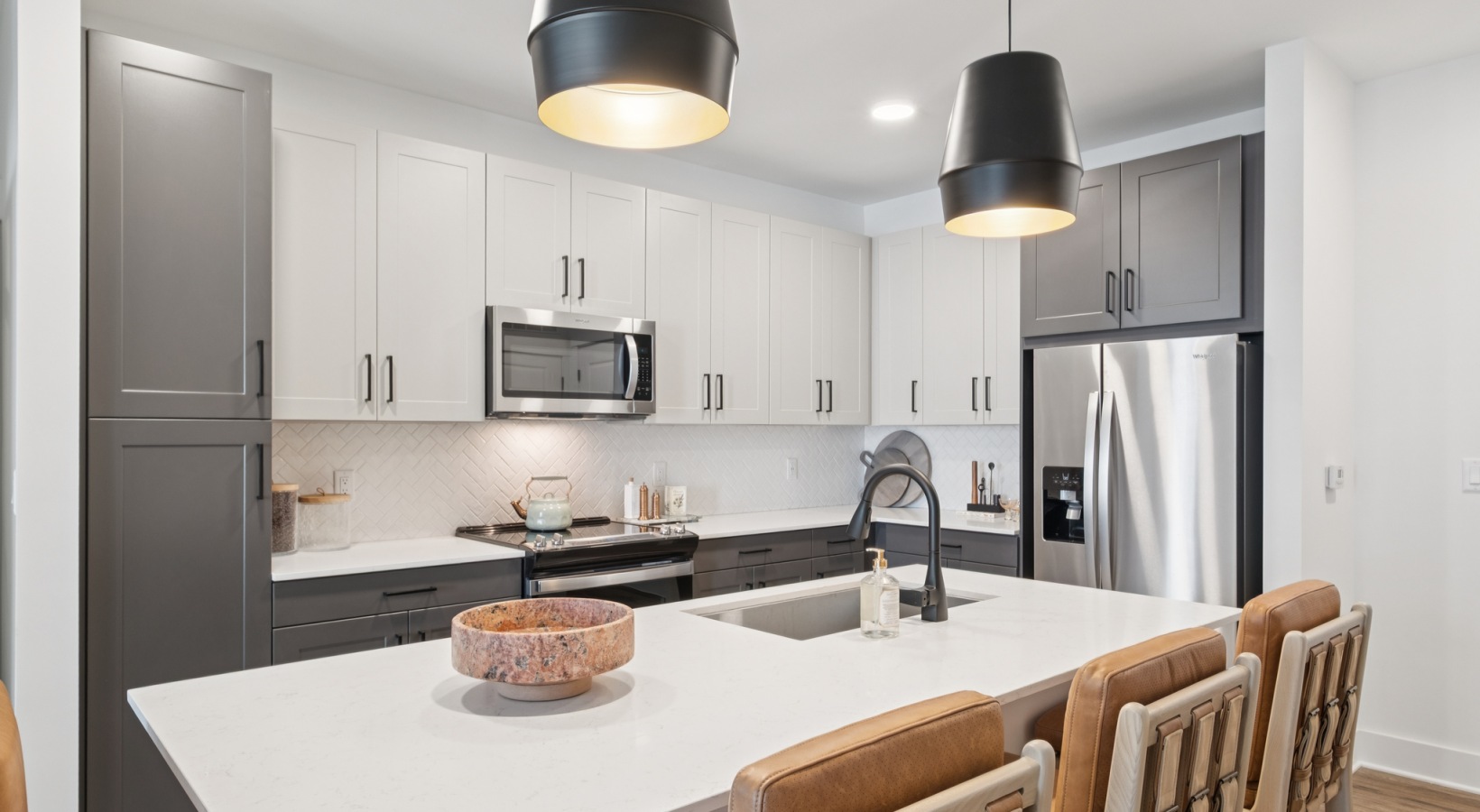 Chic modern kitchen with sleek cabinetry, spacious island, and stylish pendant lighting, perfect for culinary enthusiasts at The Rowley in Murfreesboro