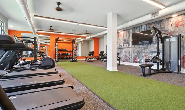 Work hard towards your goals at The Rowley's 24/7 fitness center Fitness center with green turf, weight lifting equipment, cardio machines, and more