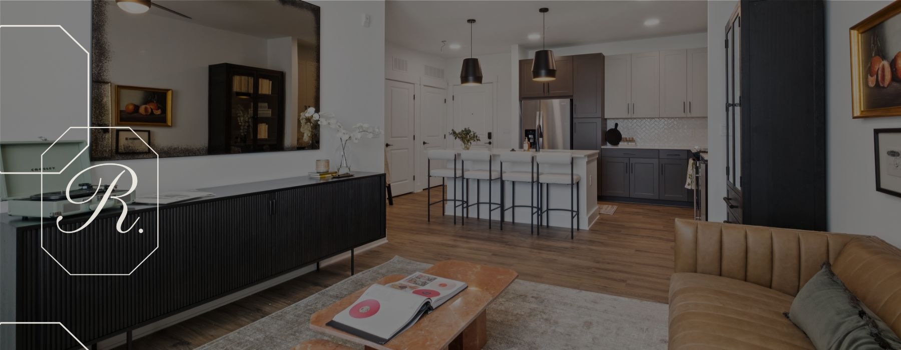 Living with brown leather couch and stunning kitchen with barstools 